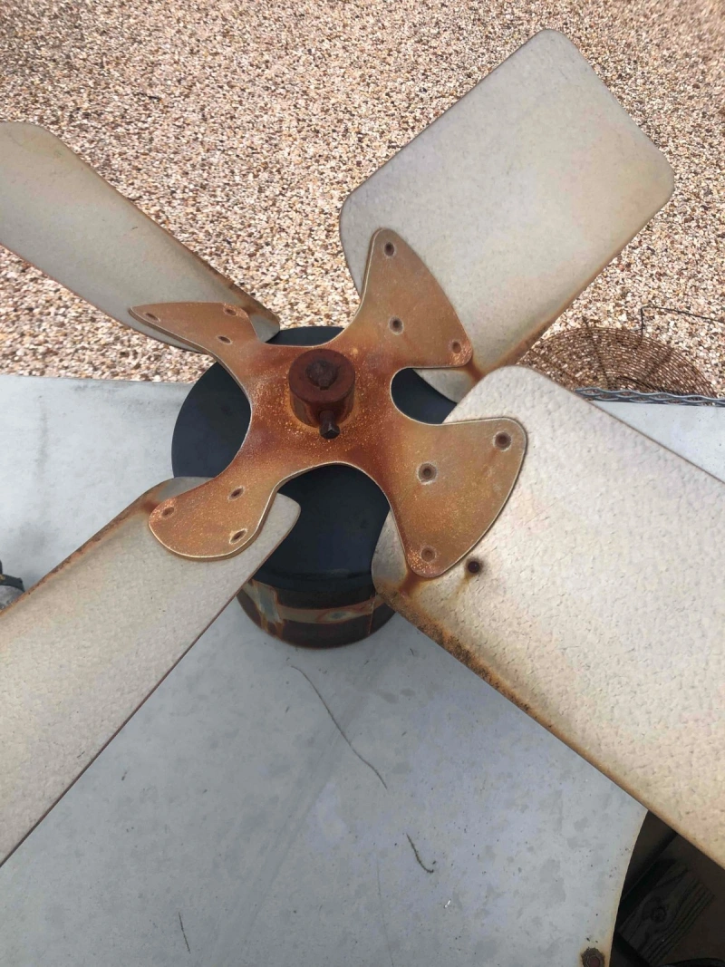 AC fan blades removed from the unit and on the ground following a cleaning