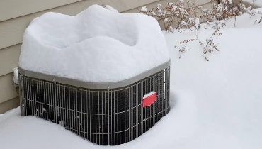 AC unit covered with snow | Aire Serv