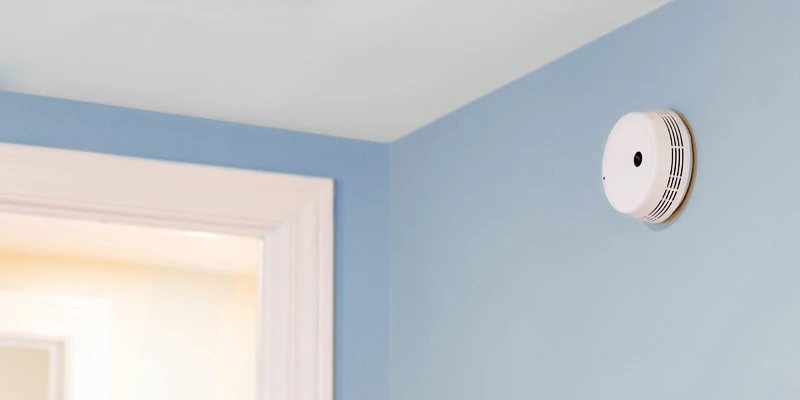 Smoke detector mounted to blue wall