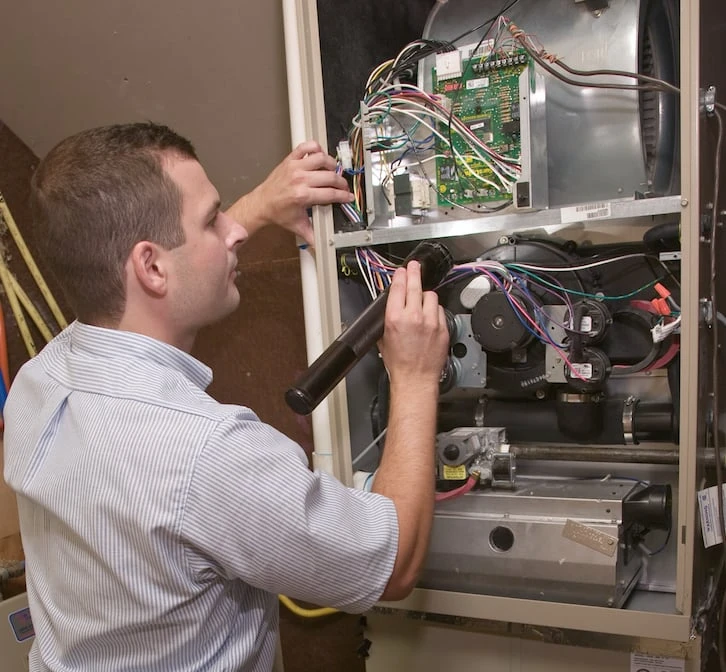 ASV technician repairing heating system.