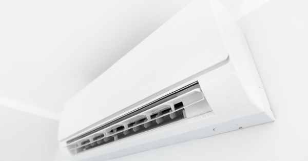 Large indoor AC unit mounted on white wall.