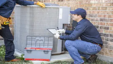 Multi-ethnic team of blue-collar air conditioner repairmen at work | Aire Serv of North Central Arizona.