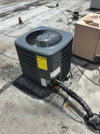 The outdoor part of an air conditioning system installed on a roof.