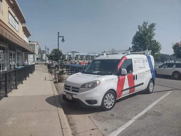 Aire Serv branded van parked in downtown Pewaukee, WI.